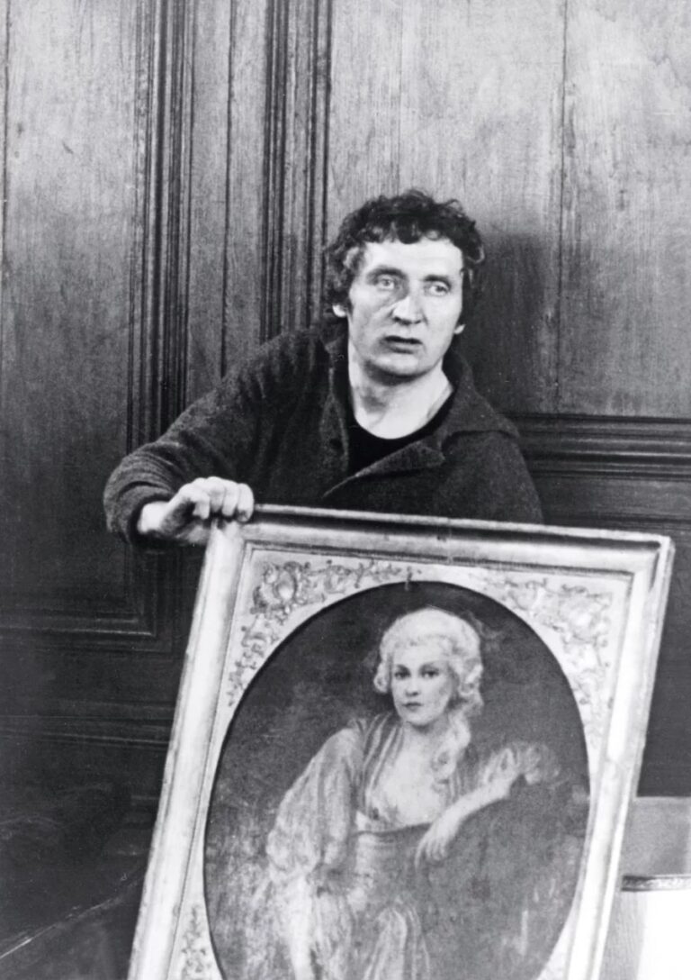 Black and white still of a man holding a framed oval portrait, from the cinema of Walerian Borowczyk