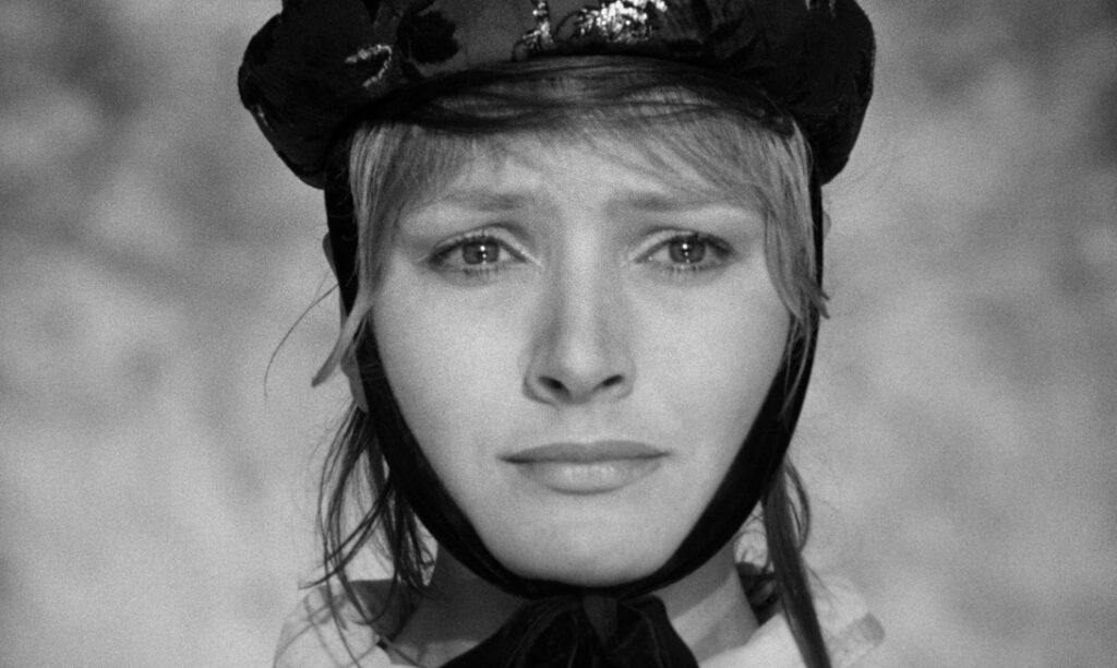 Close-up of Ligia Branice beneath a dark cap in Goto, l&rsquo;ile d&rsquo;Amour (1968)