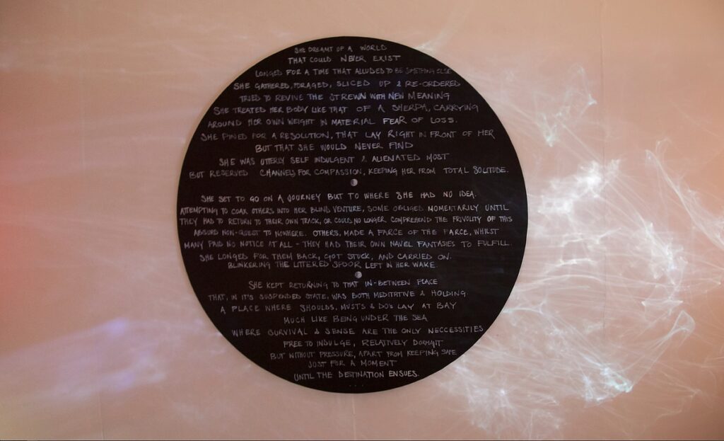The circular blackboard of Spoor by Natasha Bourke, chalked with a confessional statement